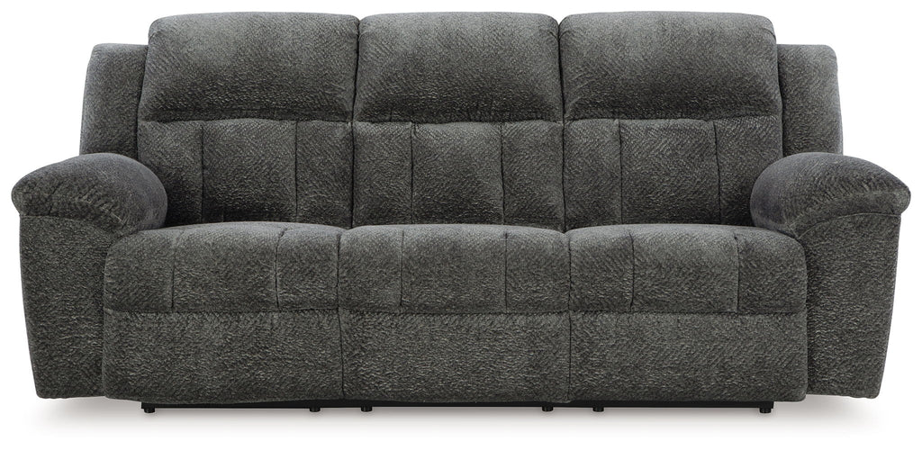 Reclining sofa in gray fabric with tufted back cushions and padded armrests