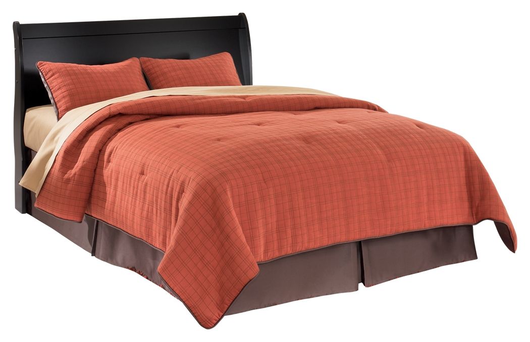 Black queen sleigh headboard with curved upholstered top, with pillows and quilt