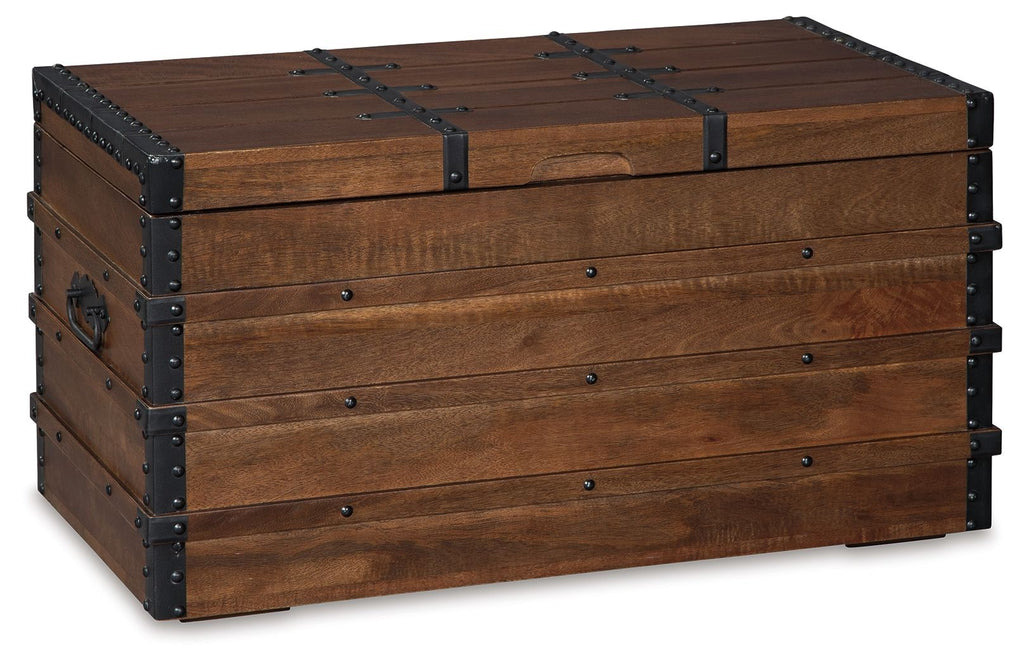 Brown wooden storage trunk with hinged lid, black metal corner studs, and front latch panel.