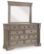 Grayish brown dresser with rectangular mirror, multiple drawer fronts and bun feet