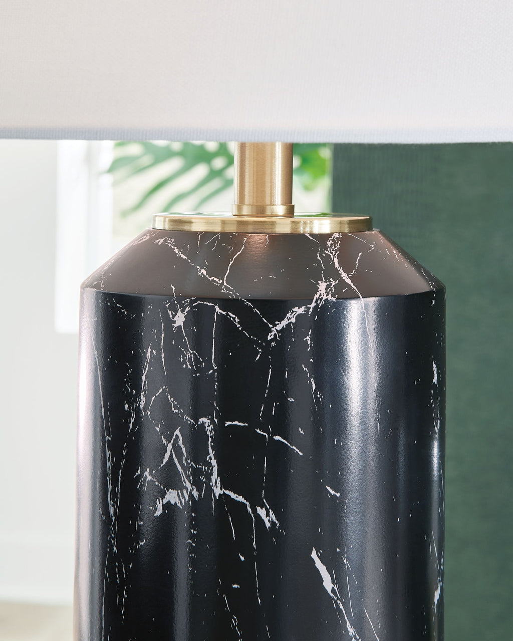Black lamp base with white marble veining and gold top collar