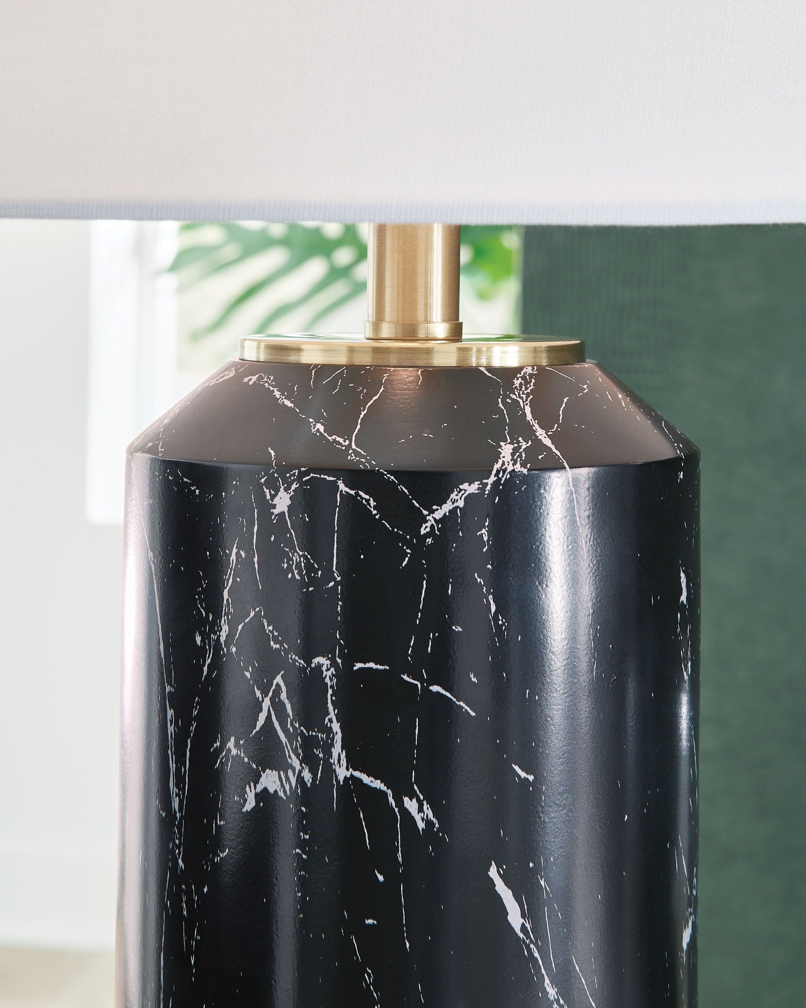 Black lamp base with white marble veining and gold top collar