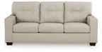 Light beige fabric sofa with tufted back and three padded seat cushions