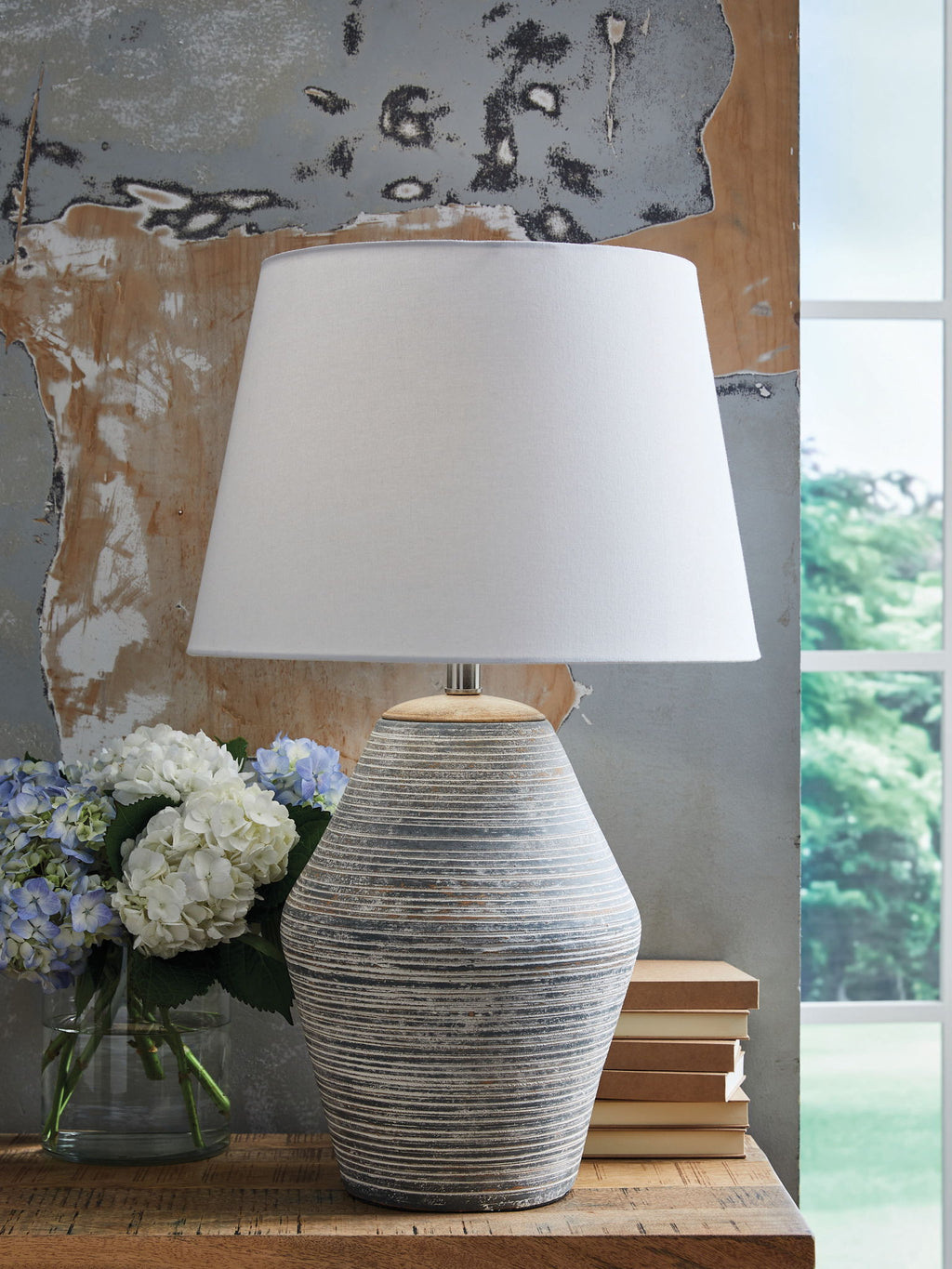 Table lamp with white fabric shade and blue-gray ribbed ceramic base