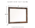 Bedroom mirror with rectangular dark brown frame and beige distressed edging
