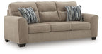 Light brown sofa with three seat cushions and two striped throw pillows