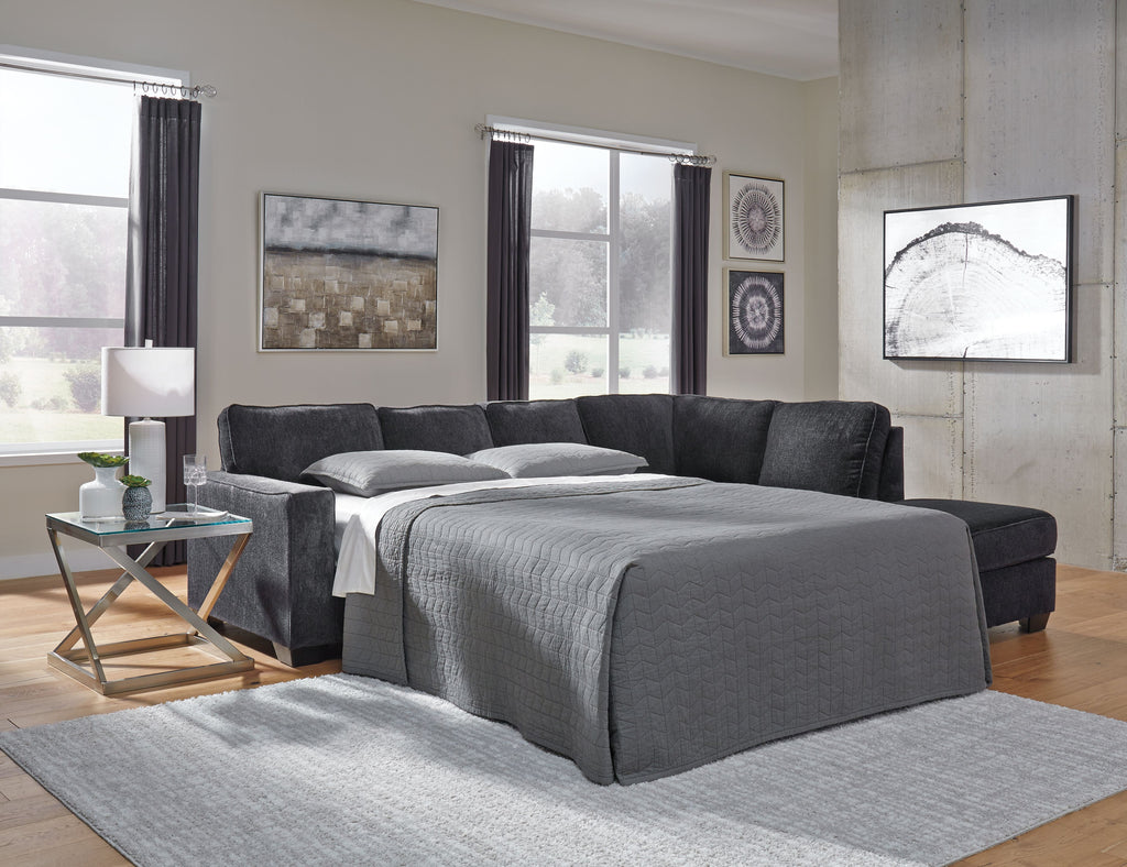Dark gray sofa sleeper with pull-out bed surface and matching pillows