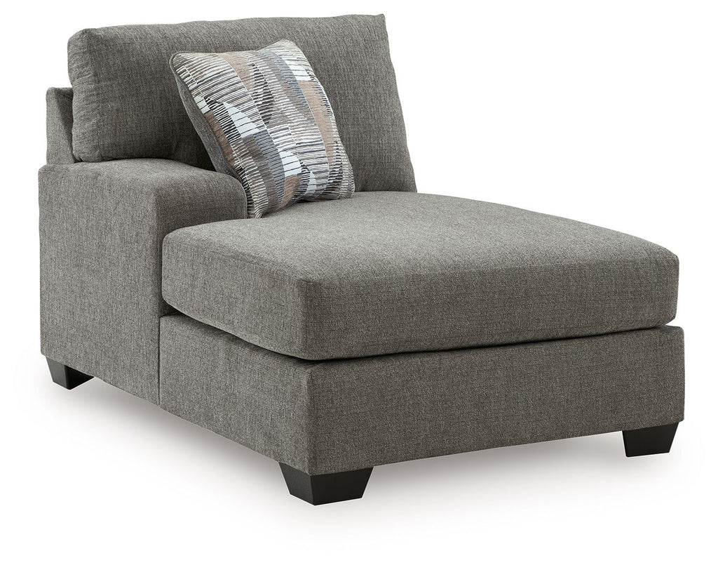 Greystone corner chaise with textured gray fabric and two accent throw pillows