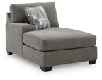 Greystone corner chaise with textured gray fabric and two accent throw pillows