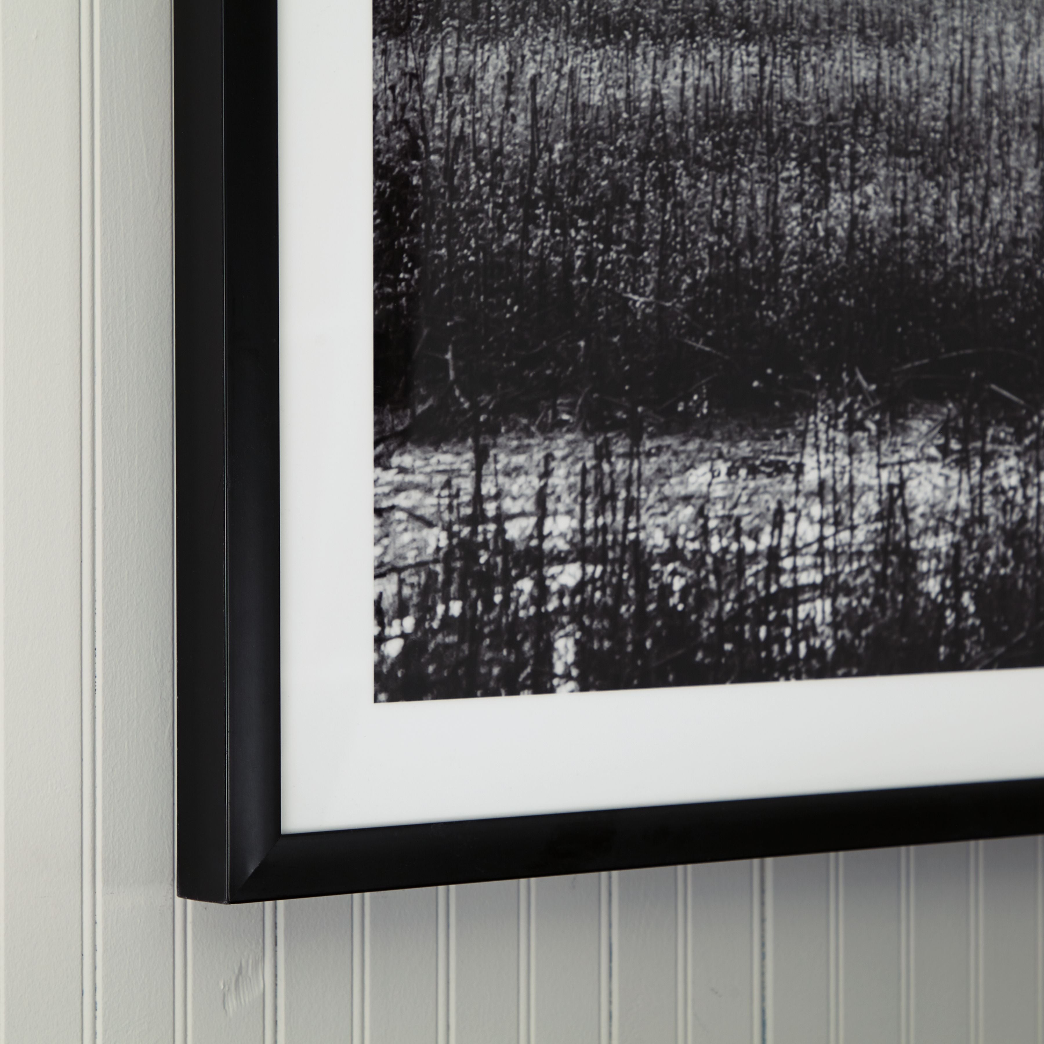 Framed wall art with black frame and black-and-white textured panel