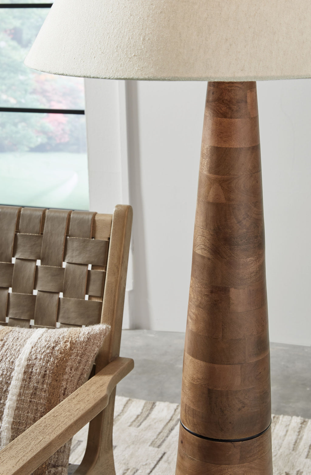 Wood floor lamp with cream fabric shade and dark brown tapered segmented base