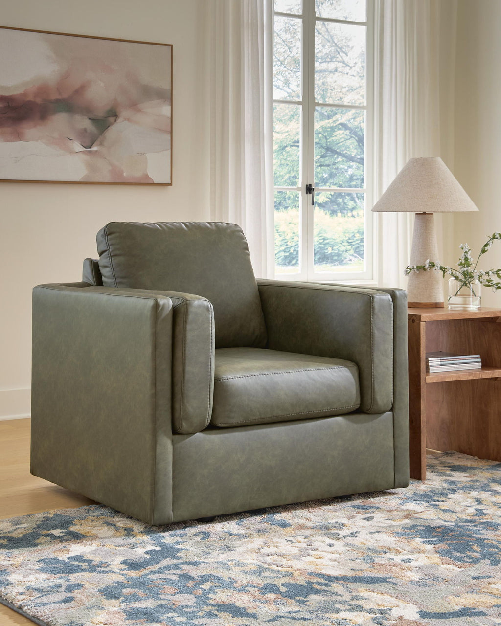 Olive green upholstered accent chair with tall back, padded arms, and cushioned seat