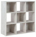 Whitewashed wood cube organizer with open square cubbies and divider shelves