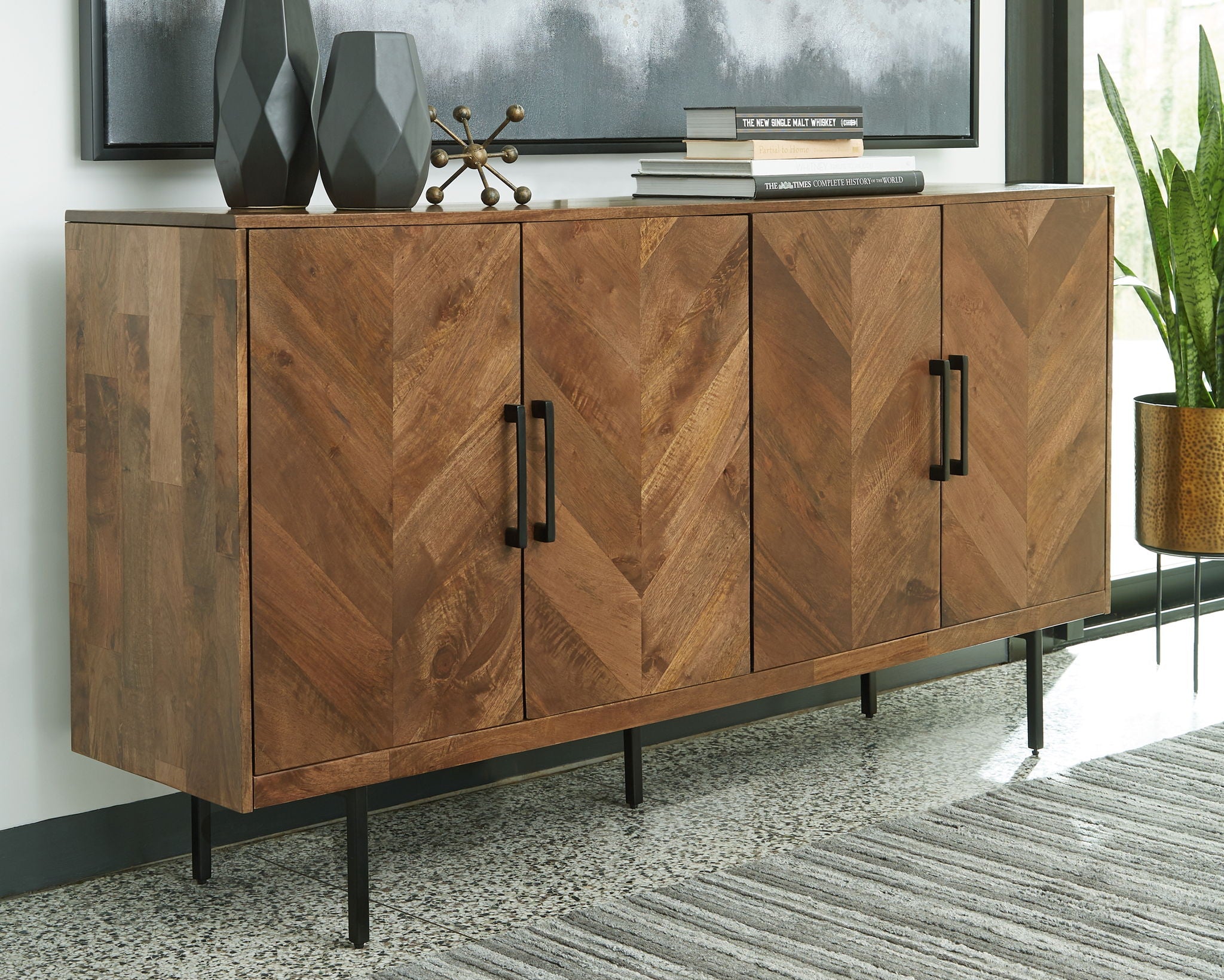 Brown accent cabinet with four panel doors and black bar handles