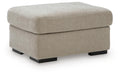 Light beige upholstered ottoman with square top and black legs