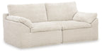 Ivory corner chair with three seat cushions and rounded armrests