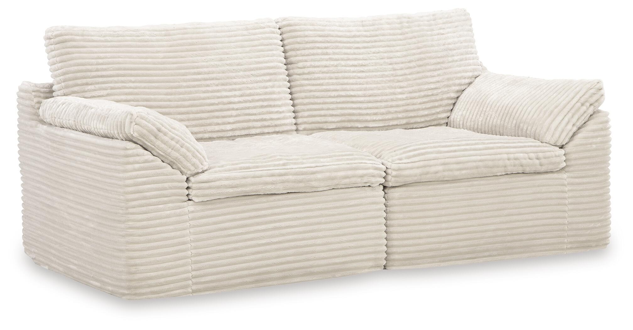Ivory corner chair with three seat cushions and rounded armrests