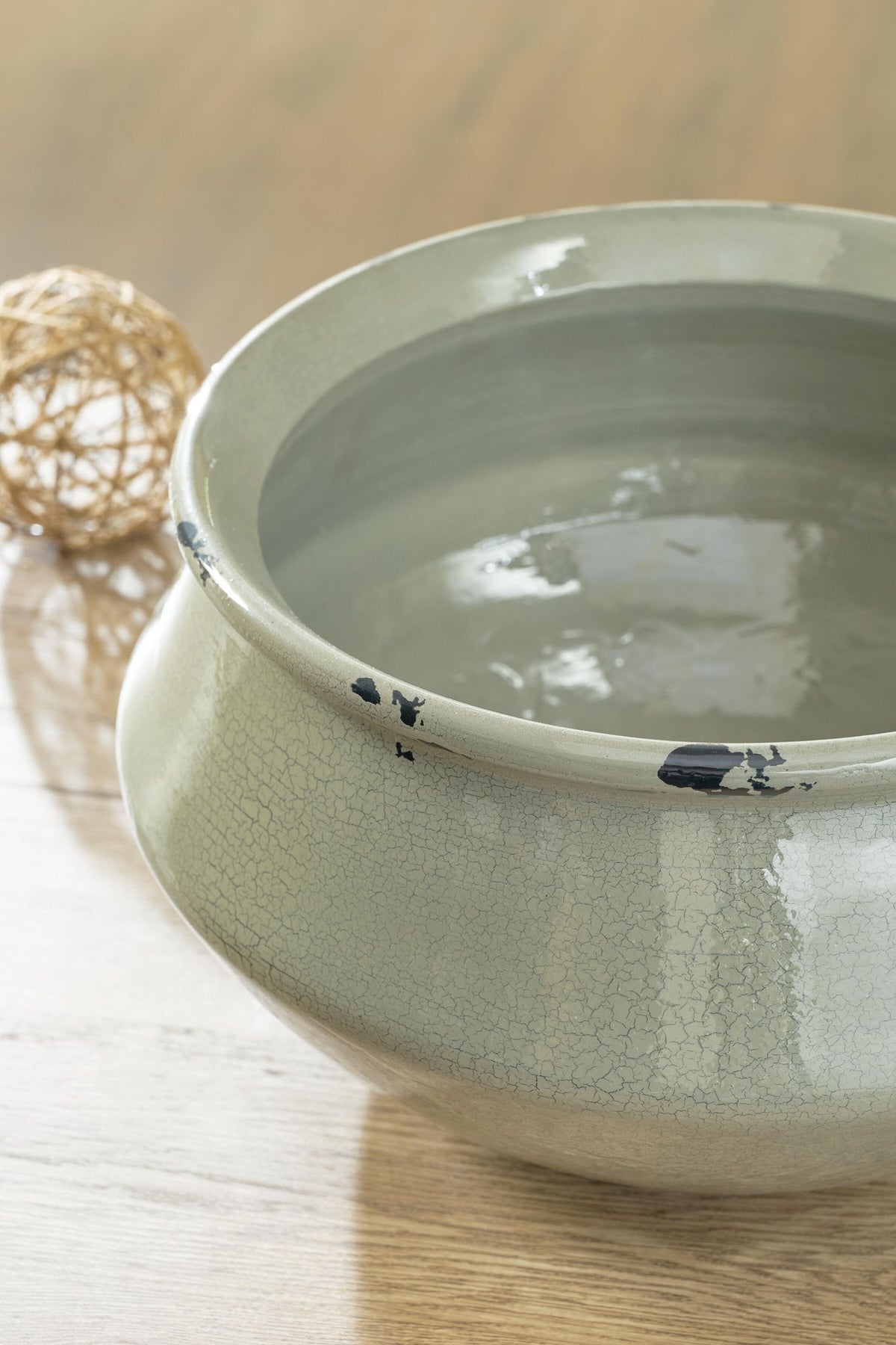 Sage ceramic bowl with crackle glaze and black accents, wide open rim