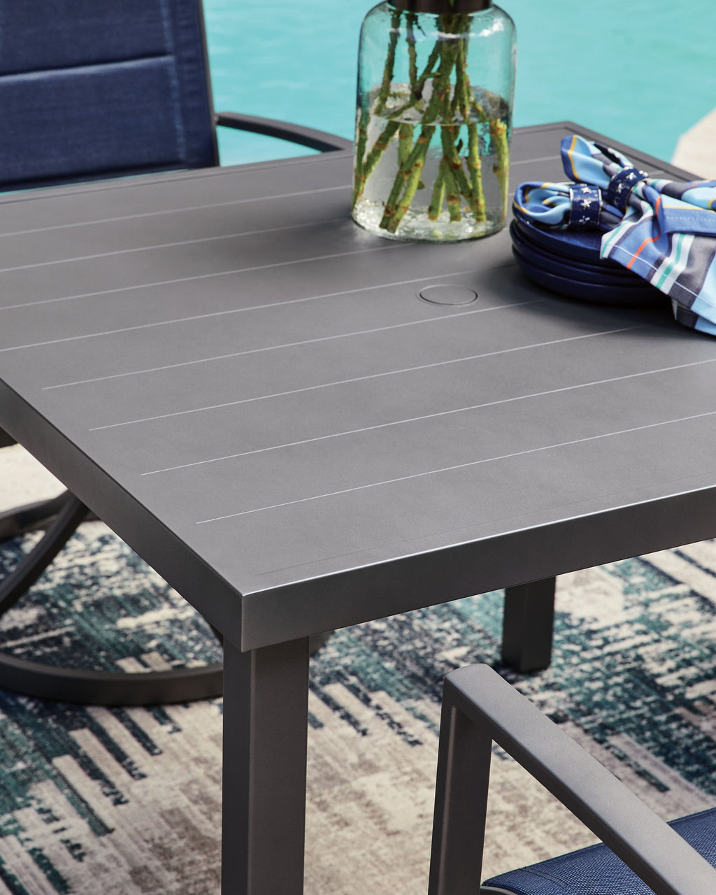 Gray square dining table with round umbrella hole in the tabletop