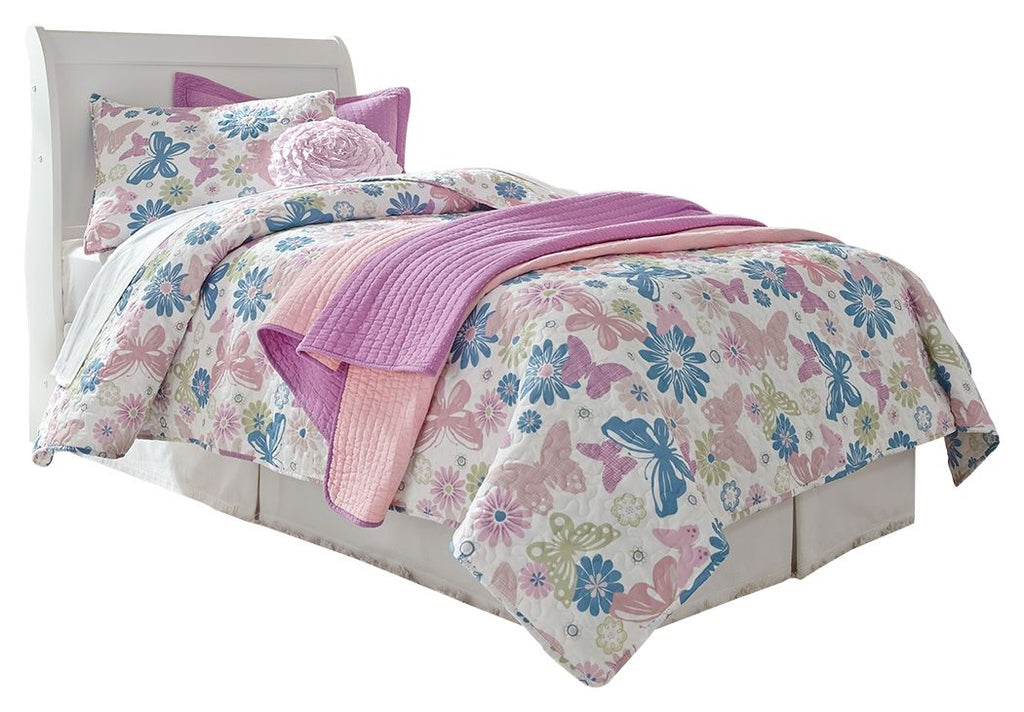 White sleigh bed headboard with tall curved design and floral bedding set