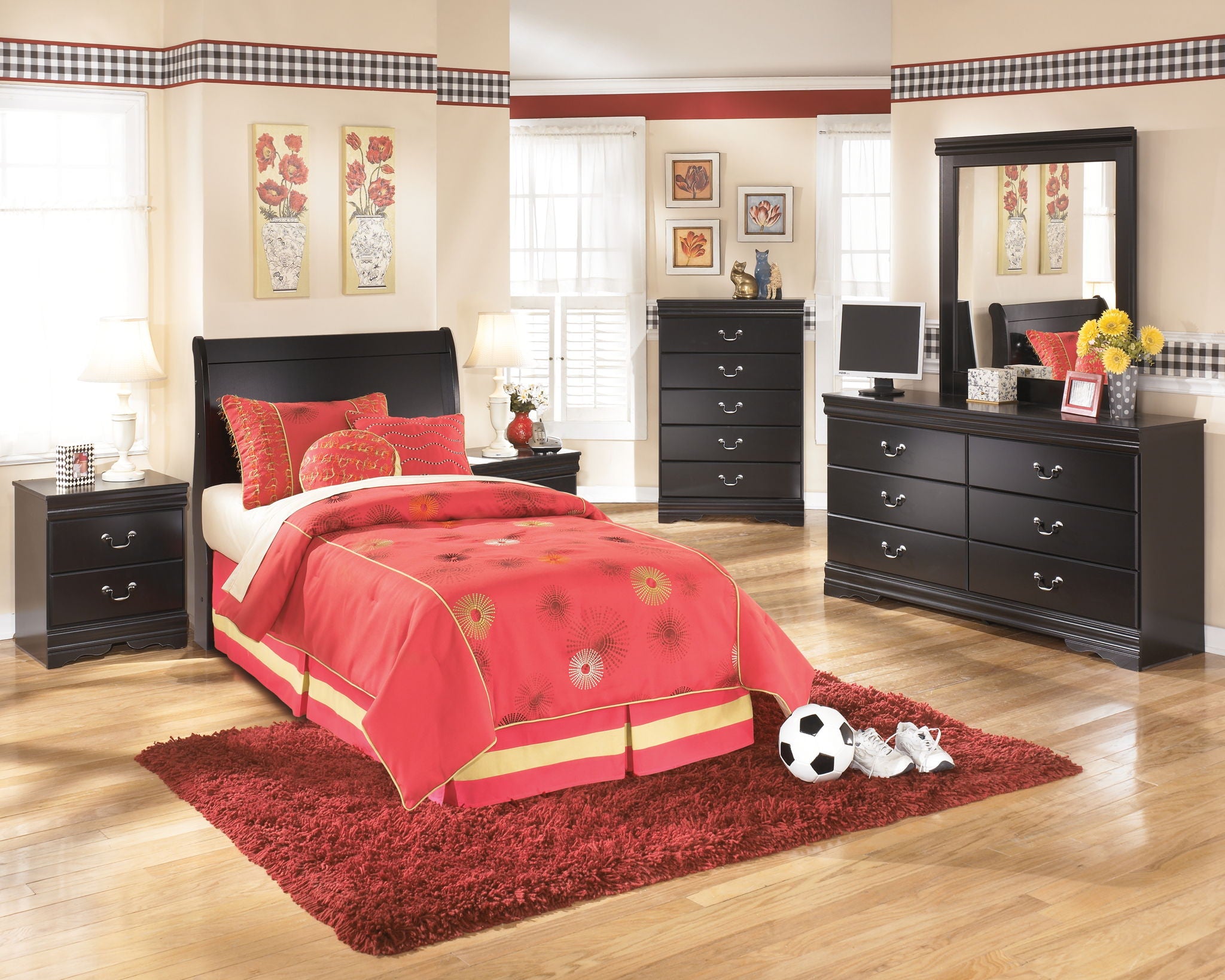 Black youth sleigh headboard with arched top and padded frame behind bed