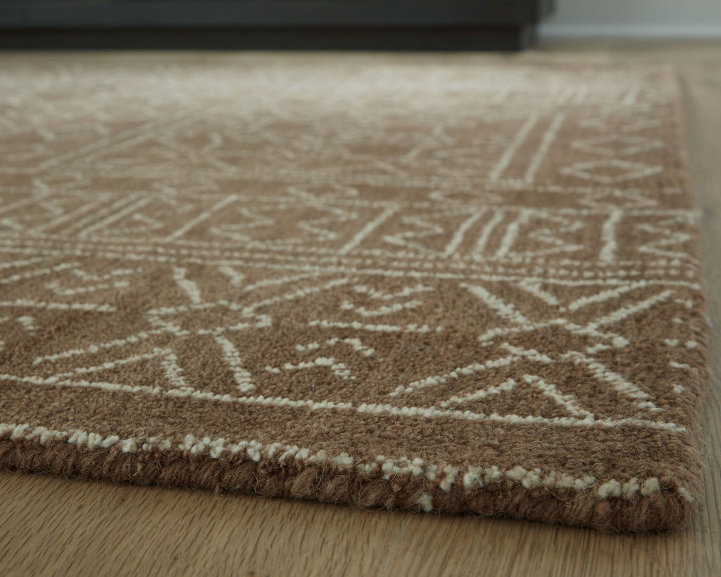 Textured rug close-up with dark brown pattern lines on beige background and trim