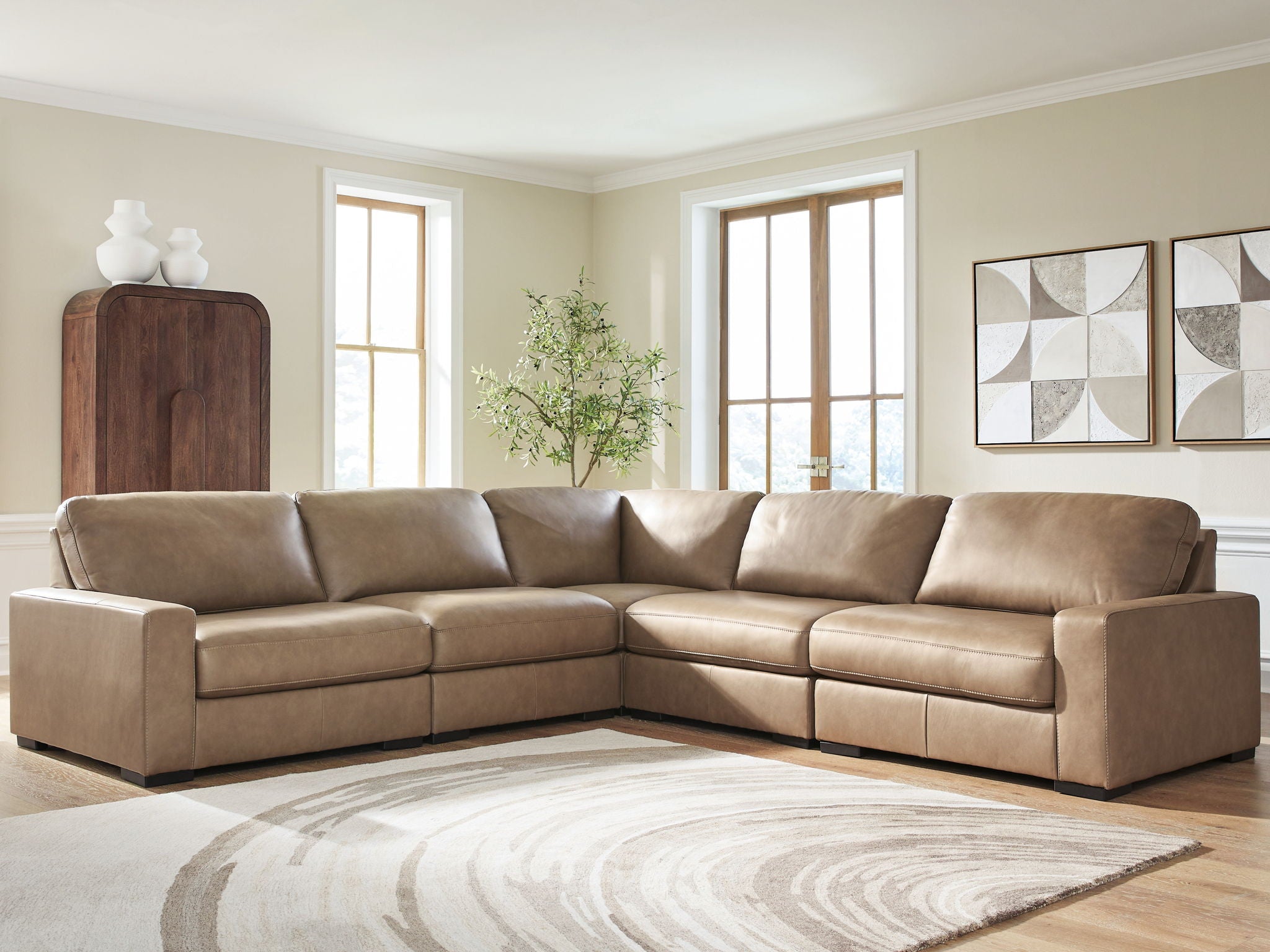 Corner sectional sofa in taupe upholstery with clean-lined arms and padded seat cushions