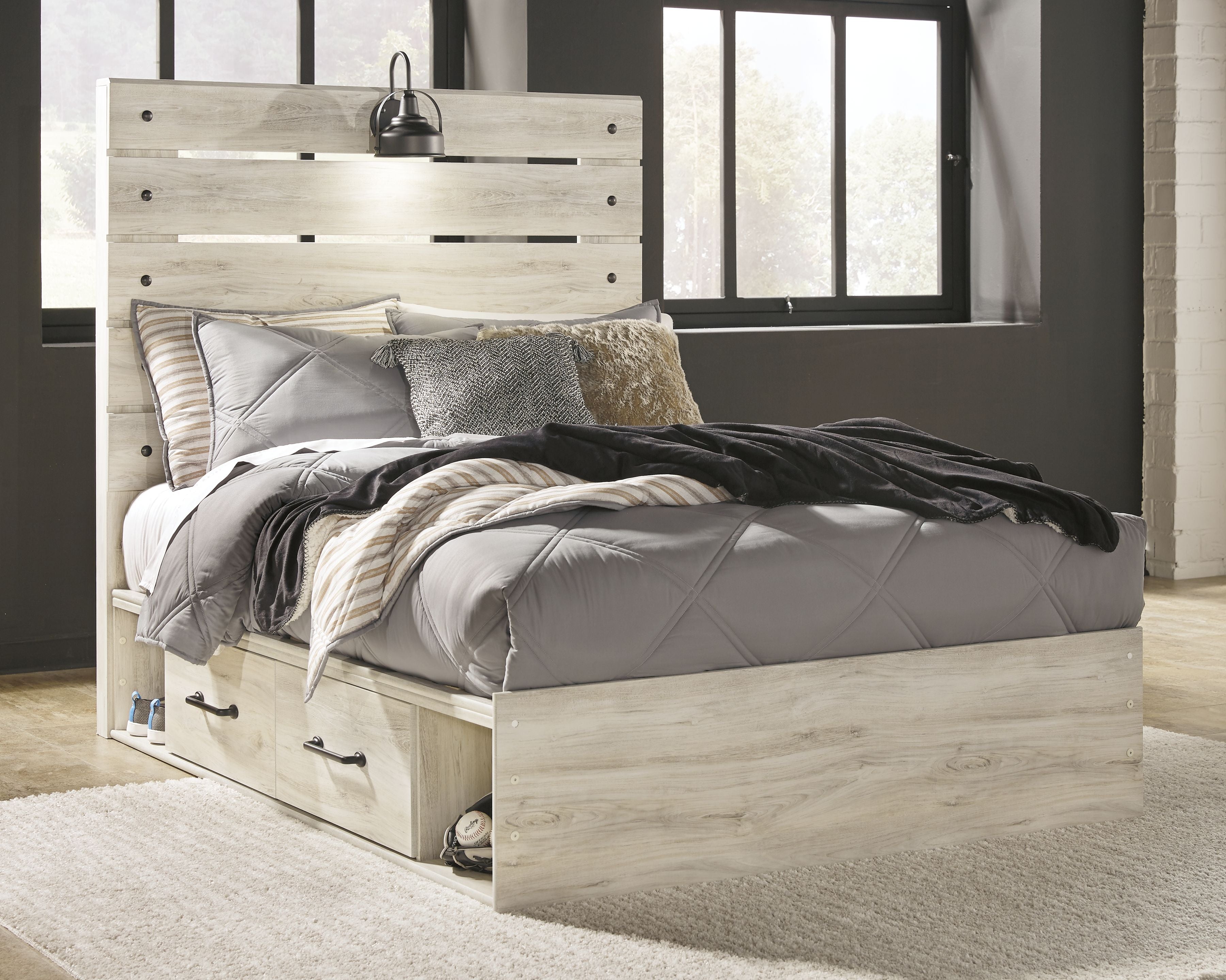 Youth bedroom bed set with paneled headboard, light wood frame, and gray comforter