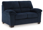 Navy corduroy loveseat with rolled arms, padded seat, and boxy back cushions