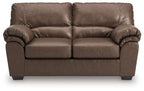 Dark brown reclining sofa with two seat cushions and tufted back pillows