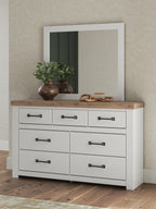 White dresser with wood top, six drawers, dark bar pulls, wall mirror