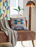 Kennick pillow with blue, tan, and white abstract print on sofa