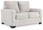 Light beige upholstered sofa with padded back and armrests