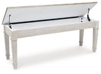 White storage bench with open lid showing storage compartment and metal lift brackets