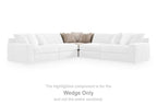 Upholstered sectional wedge sofa, light neutral upholstery, highlighted wedge section