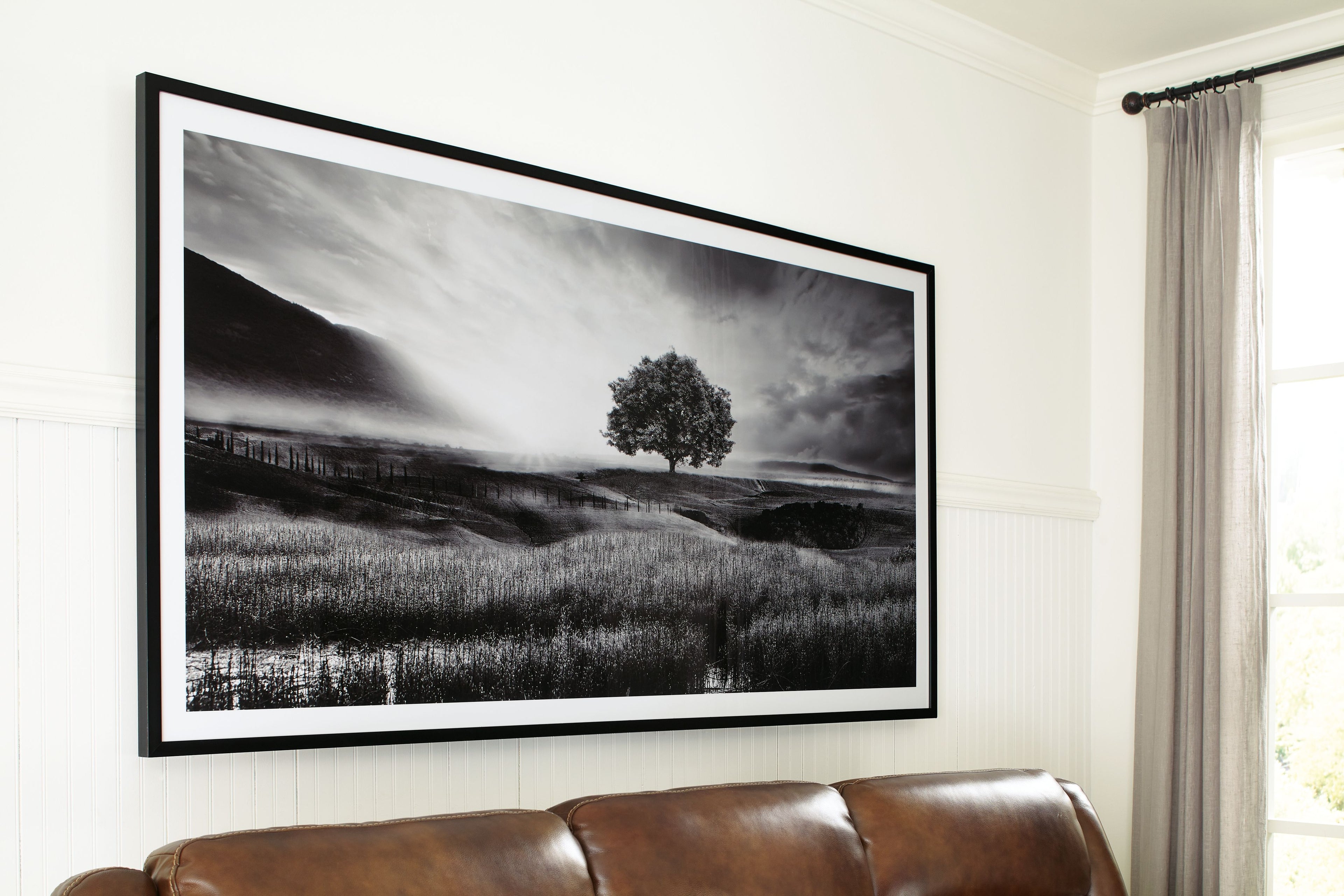 Framed black-and-white landscape wall art with lone tree and rolling hills