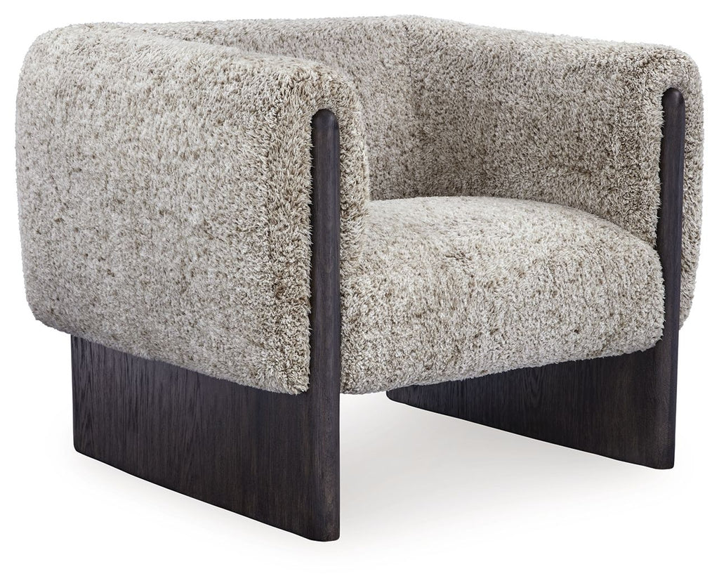 Accent chair with oatmeal boucle upholstery, dark wood legs, and rounded armrests.