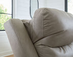 Pebble upholstered power recliner with stitched arm and back cushion