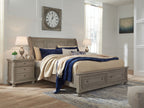 Lettner sleigh bed, gray frame with two drawers and blue-and-cream bedding