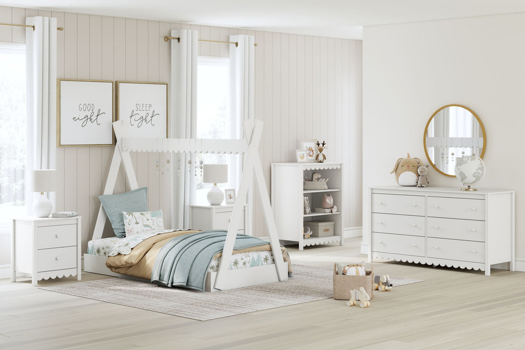 White kids bedroom set with bed, dresser, and bookcase shelves with scalloped trim