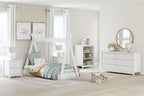White kids bedroom set with bed, dresser, and bookcase shelves with scalloped trim