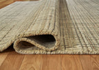 Ivory, gray, tan rug edge with folded underside showing low pile