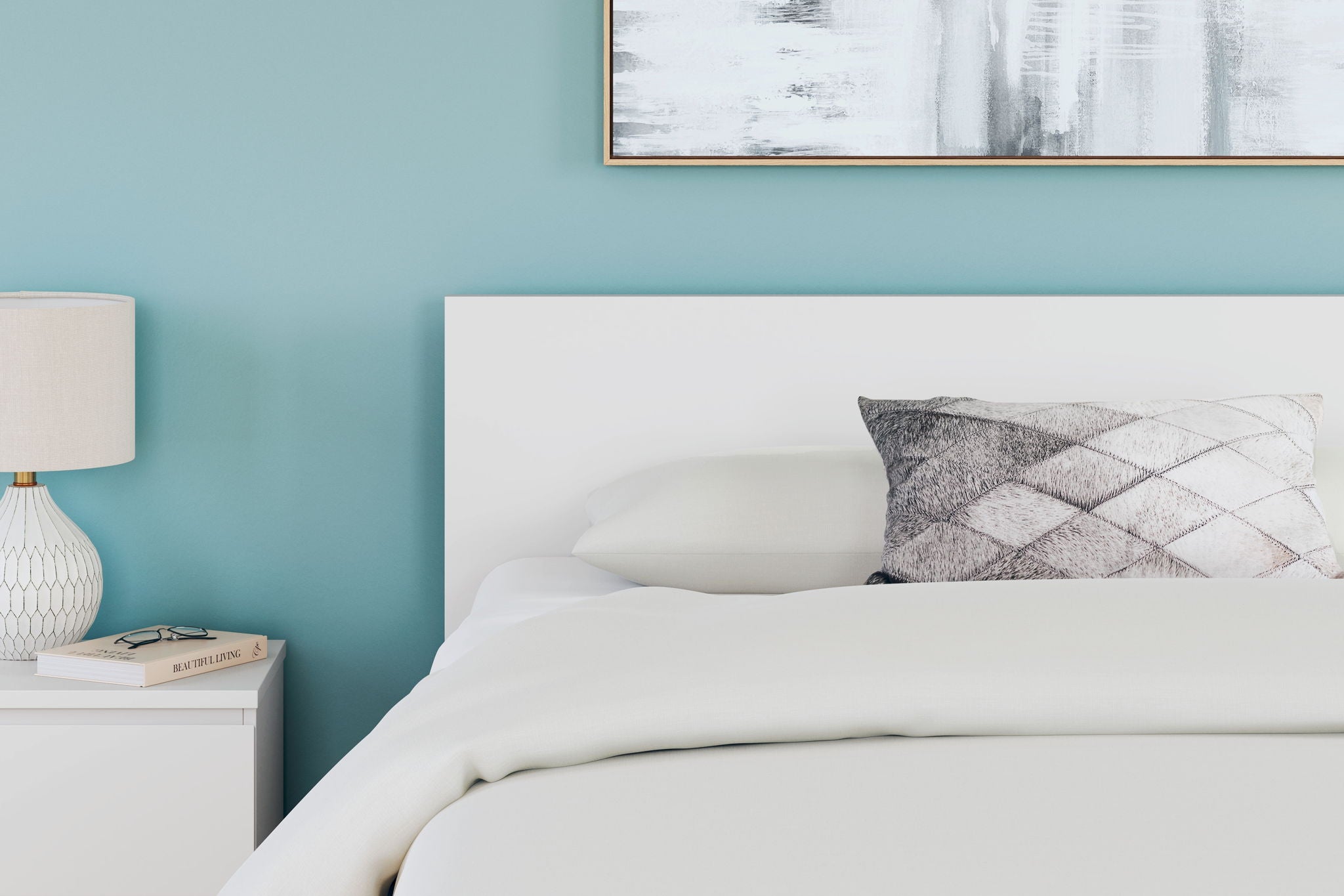 Panel headboard in light color with padded top and gray geometric accent pillows