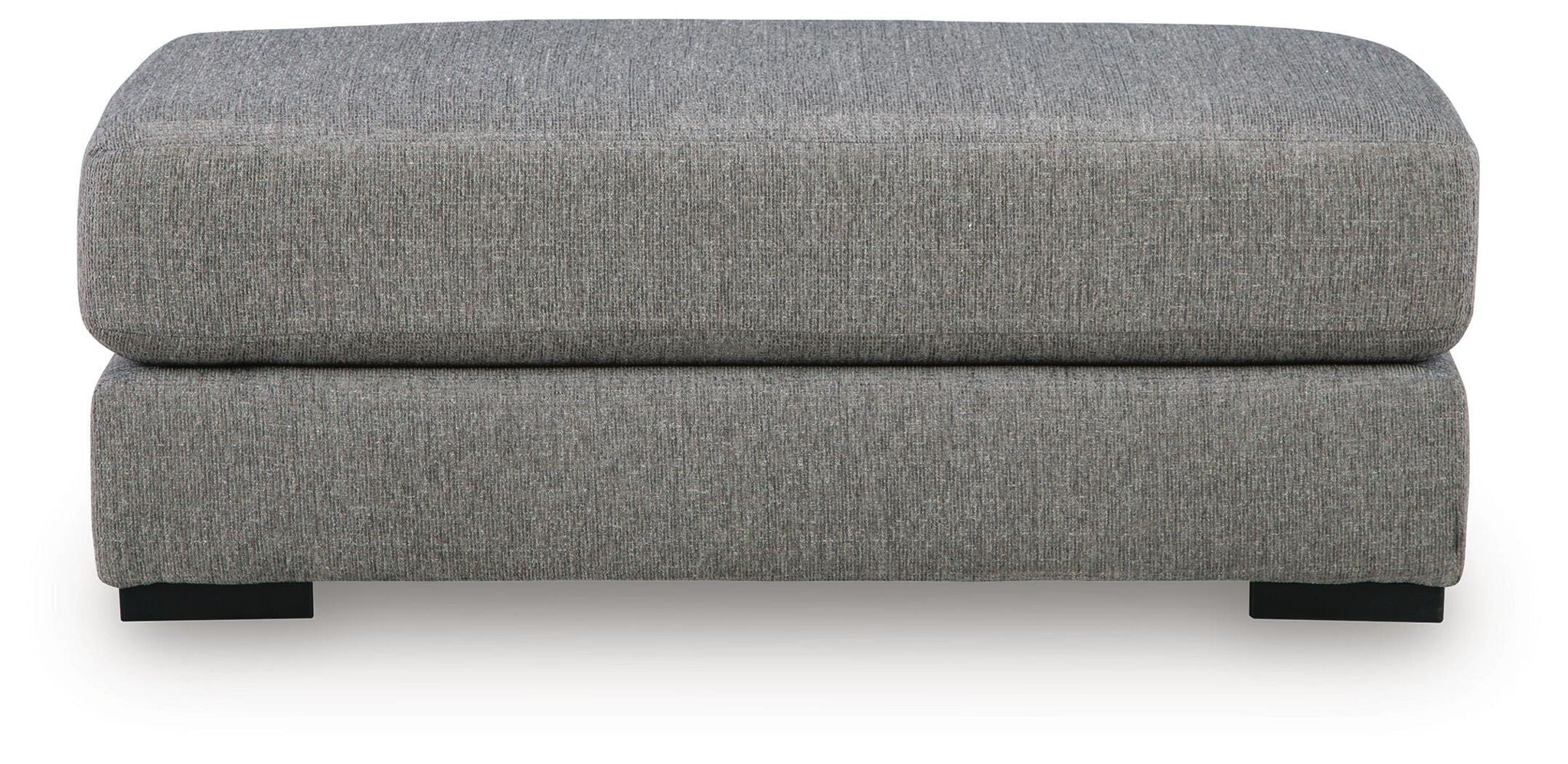 Grey upholstered ottoman with rounded top cushion and straight front profile, black legs