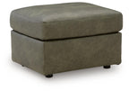 Olive-green upholstered ottoman with rounded top and short legs, square base.