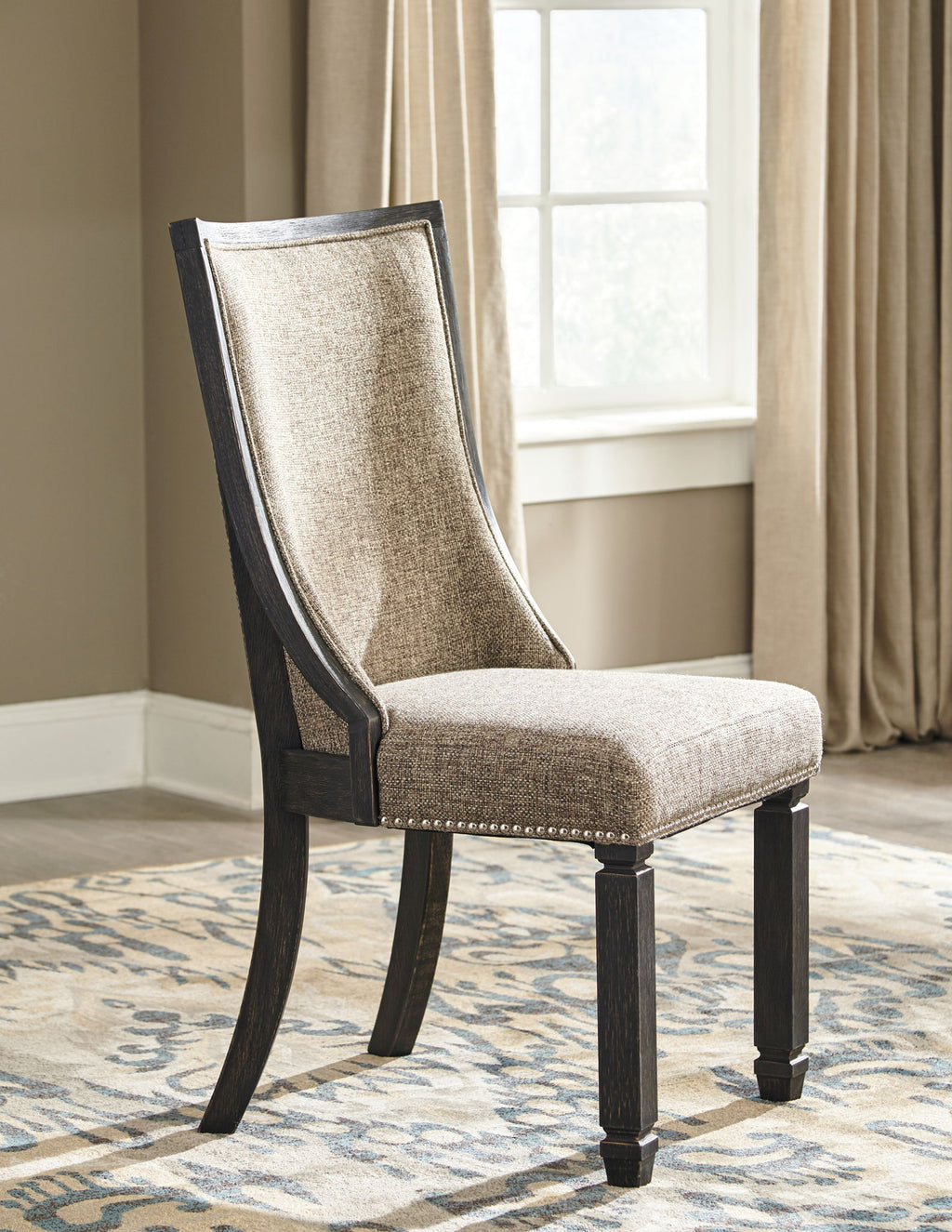 Upholstered dining side chair with framed back and nail trim, dark legs, tan upholstery