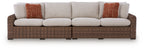 Outdoor loveseat set with beige seat cushions and brown woven frame, two rust accent pillows