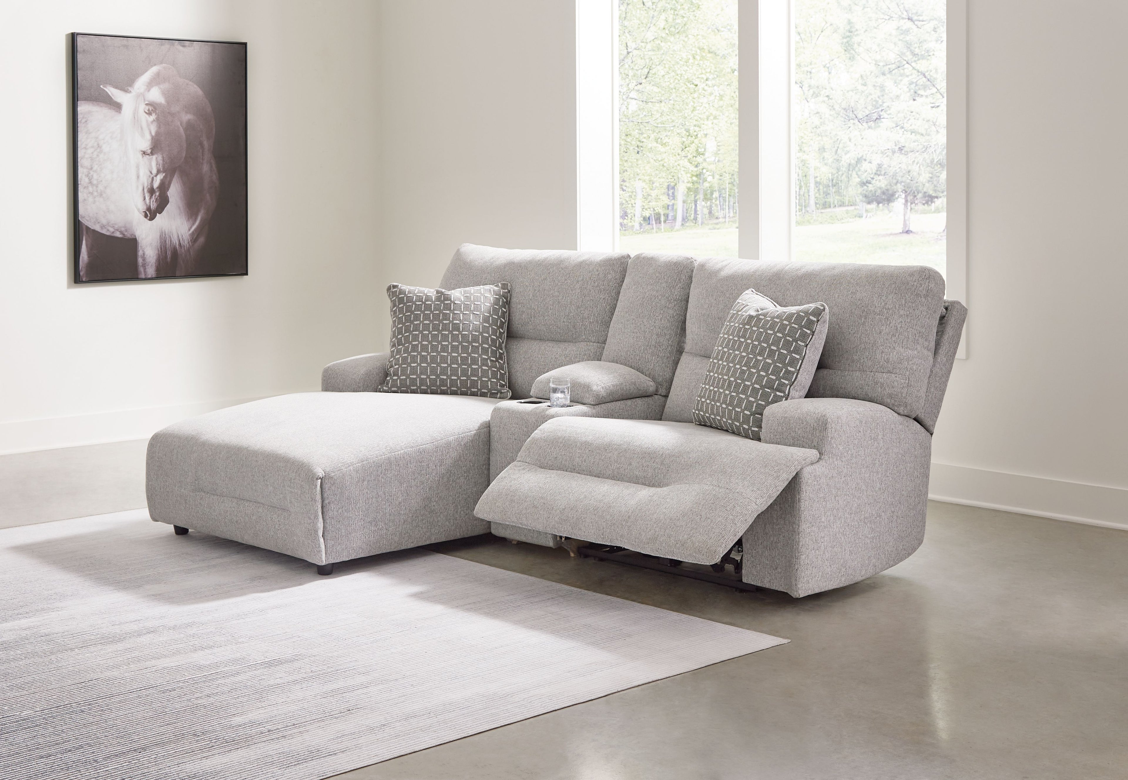 Pewter reclining sectional sofa with chaise and patterned throw pillows