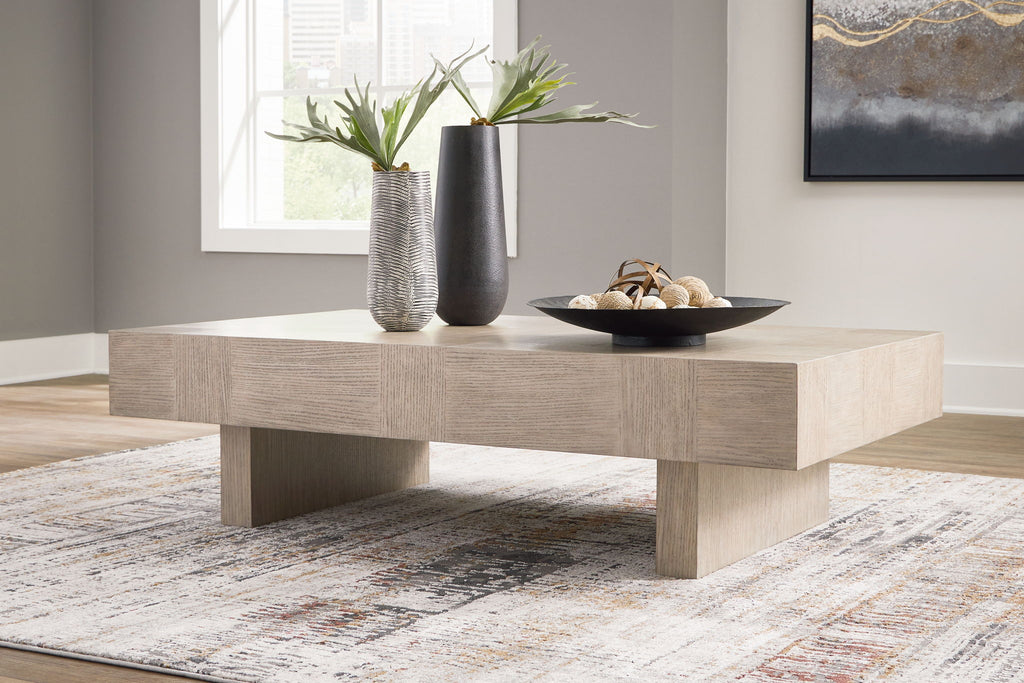 Jorlaina rectangular table with light beige finish, thick top and four wooden legs