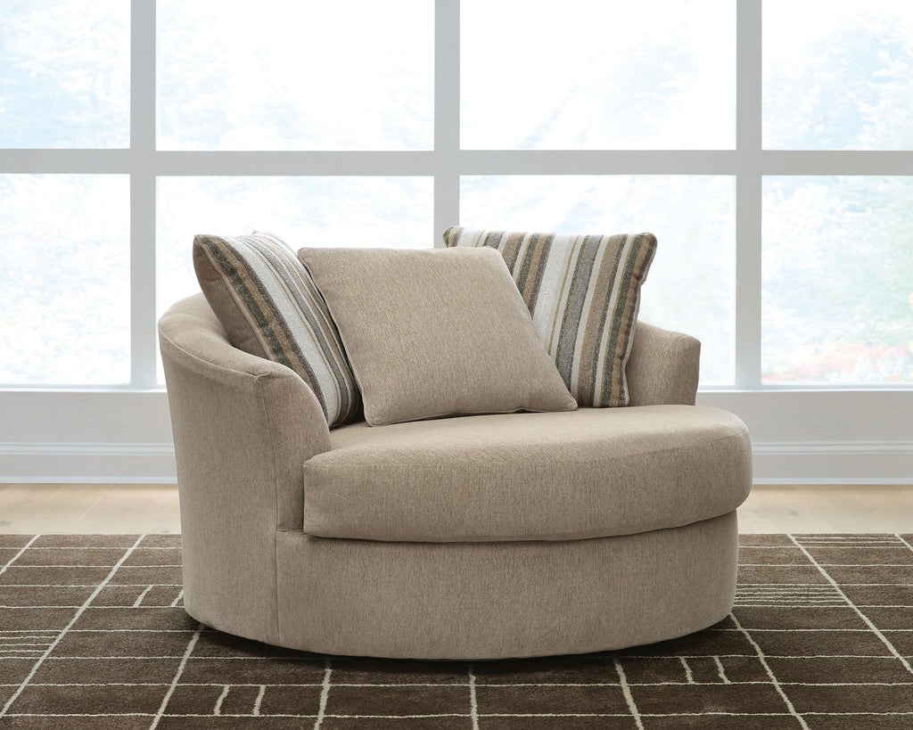 Oversized beige accent chair with rounded arms and two striped back cushions.